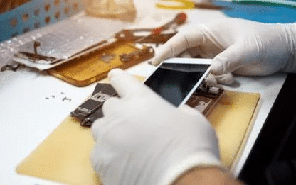 Cell phone repair close-up: technician in gloves fixing a smartphone at ER4GADGETS in Houston. ER4Gadgets
