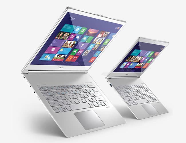 Two silver laptops with the Windows 8 interface displayed. Suitable for laptop repair. ER4Gadgets